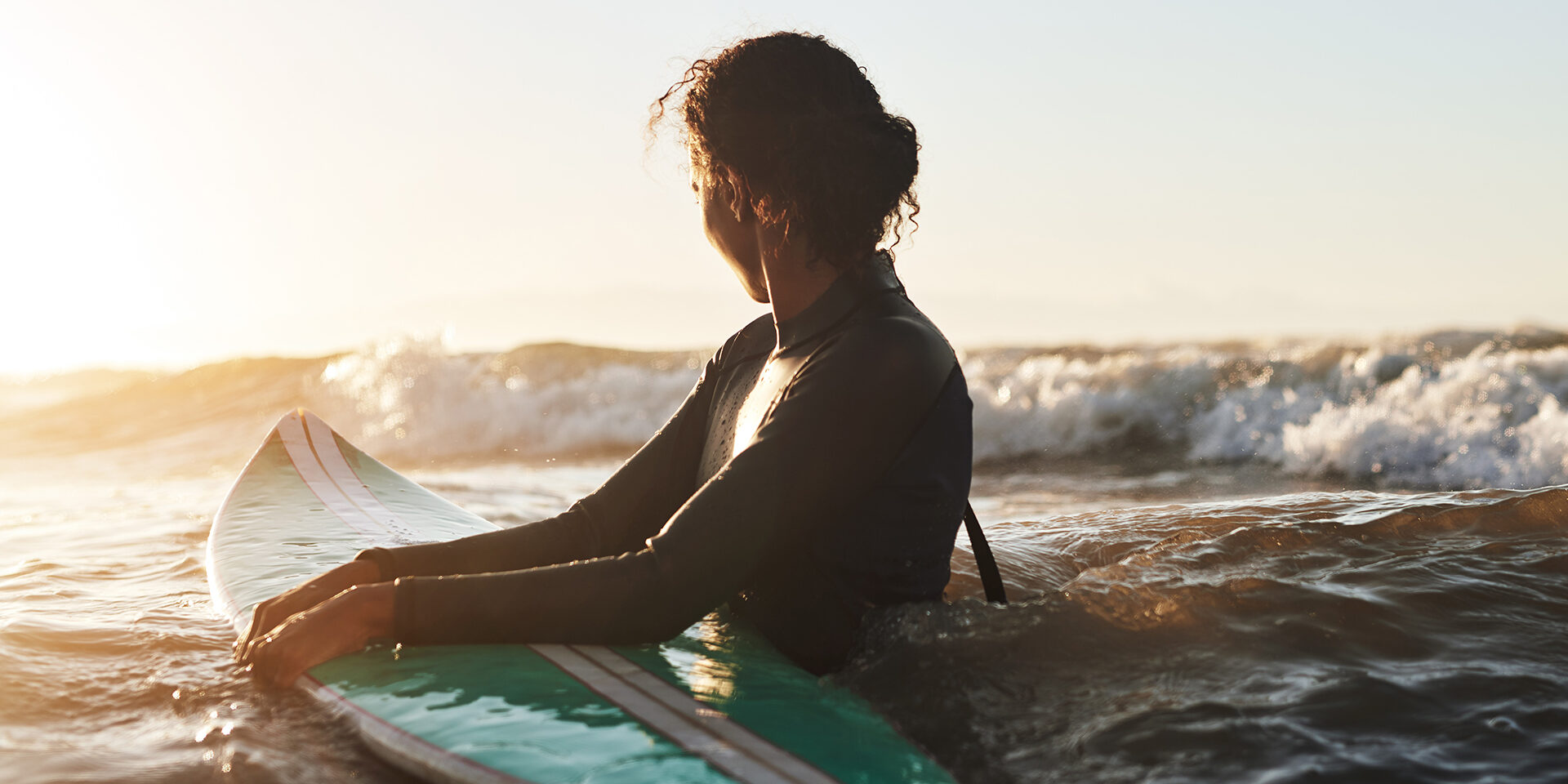 Shot of a beautiful young woman surfing in the ocean