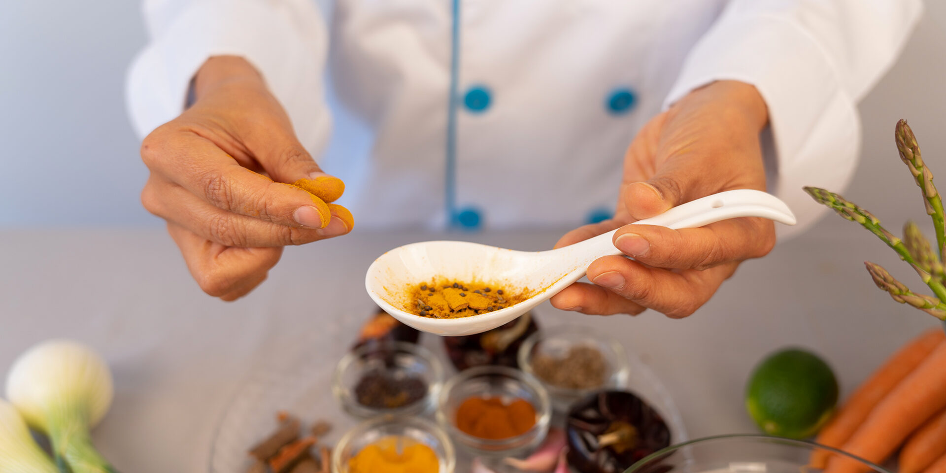 Beautiful close-up of chef hand in the kitchen manipulating color and textures of spices Chefs hands manipulating and observing the colors and textures of spices in the kitchen of her restaurant