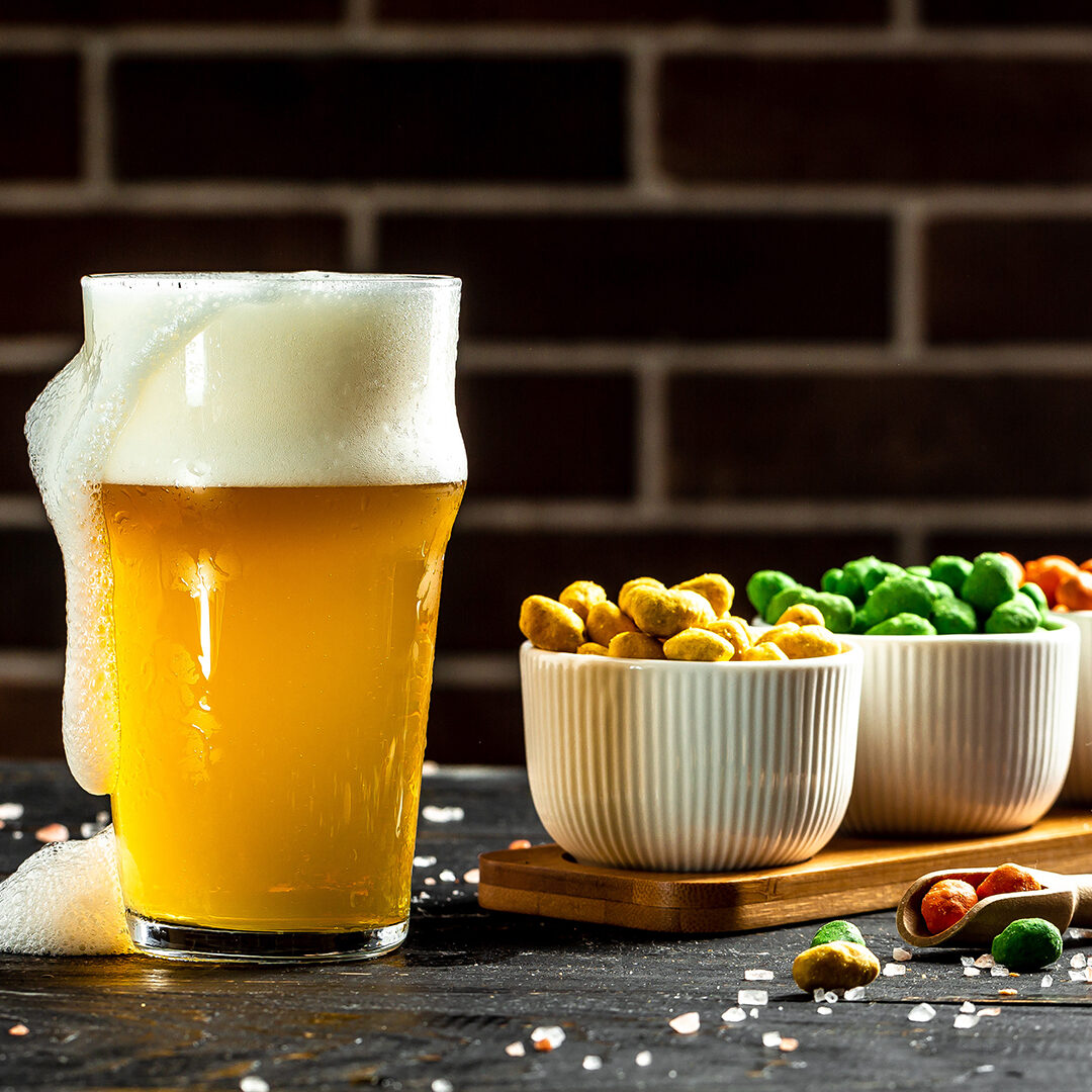 Bowl of nuts and beer on wooden table, set of peanuts with different flavors, Snacks for beer. banner, menu, recipe,