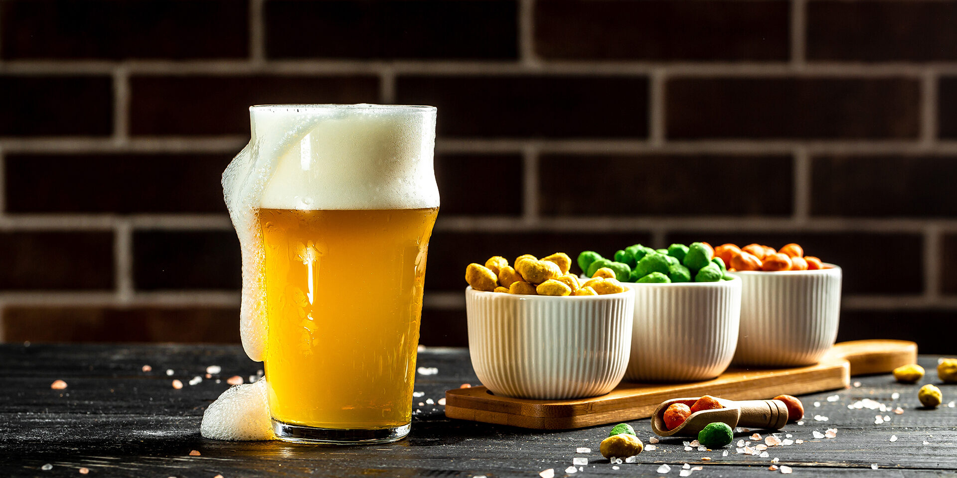 Bowl of nuts and beer on wooden table, set of peanuts with different flavors, Snacks for beer. banner, menu, recipe Bowl of nuts and beer on wooden table, set of peanuts with different flavors, Snacks for beer. banner, menu, recipe,