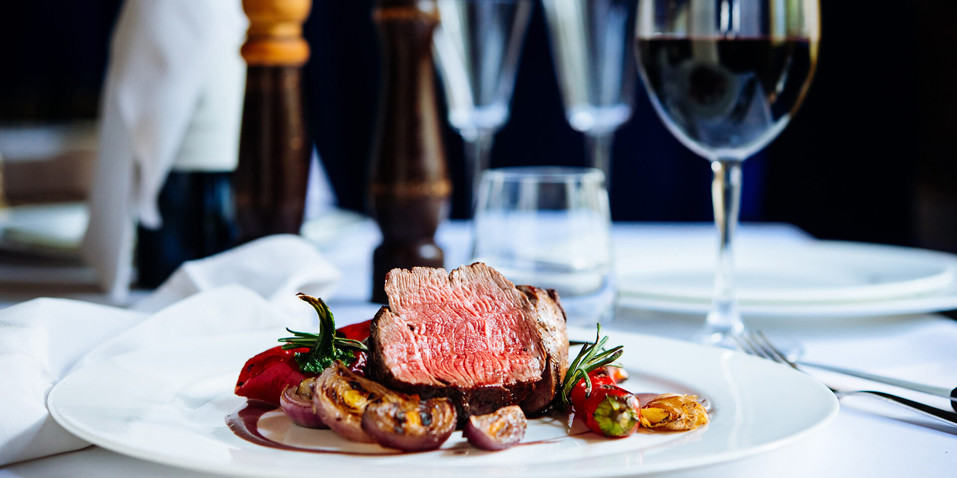 Beef steak with grilled vegetables served on white plate