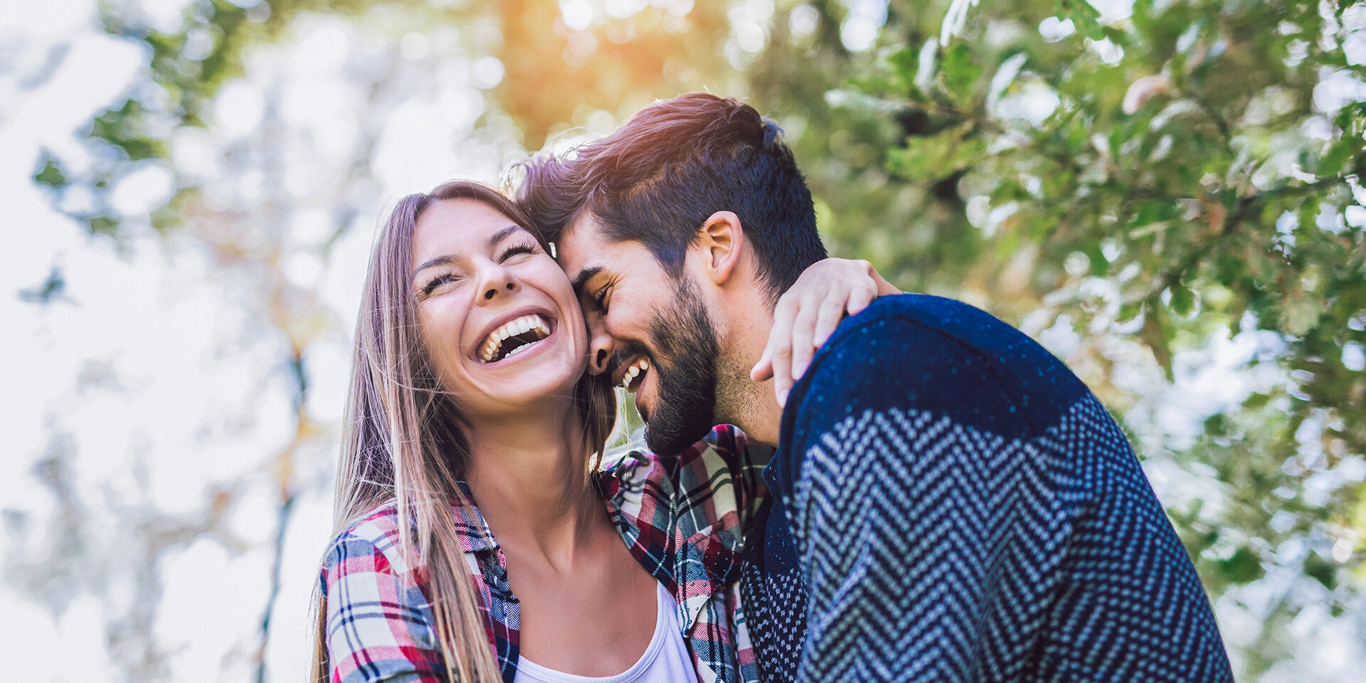 Happy couple in love having fun outdoors and smiling.