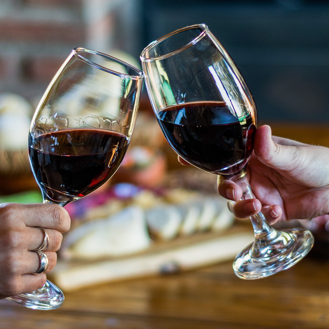 Toast with wine, with the background of a traditional finger food table