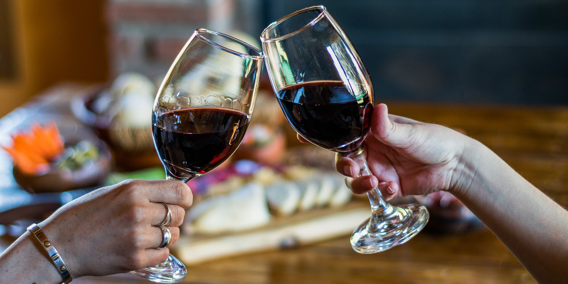 Toast with wine, with the background of a traditional finger food table