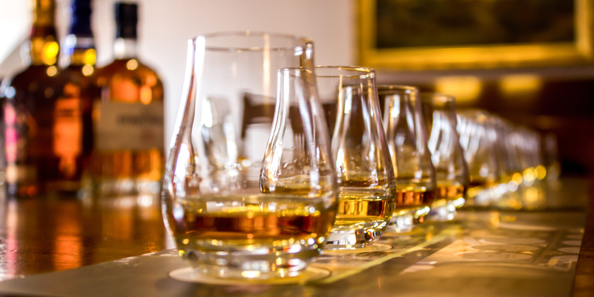 A line of whisky tasting glasses A line of tasting glasses filled with different types of Whiskies for tasting, with the focus on the second glass, the rest is out of focus