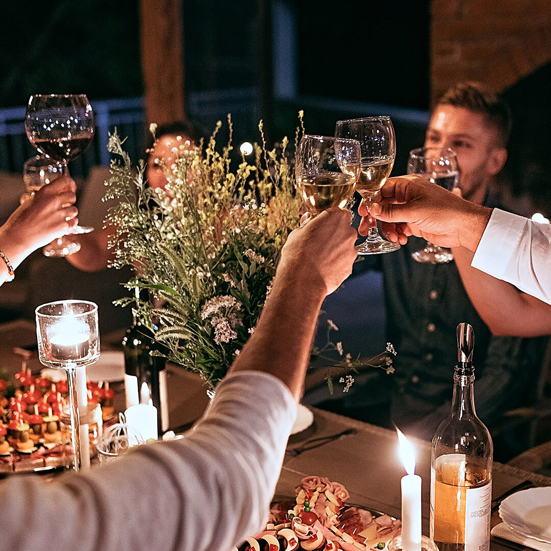 Group of friends having dinner party in backyard/holiday villa