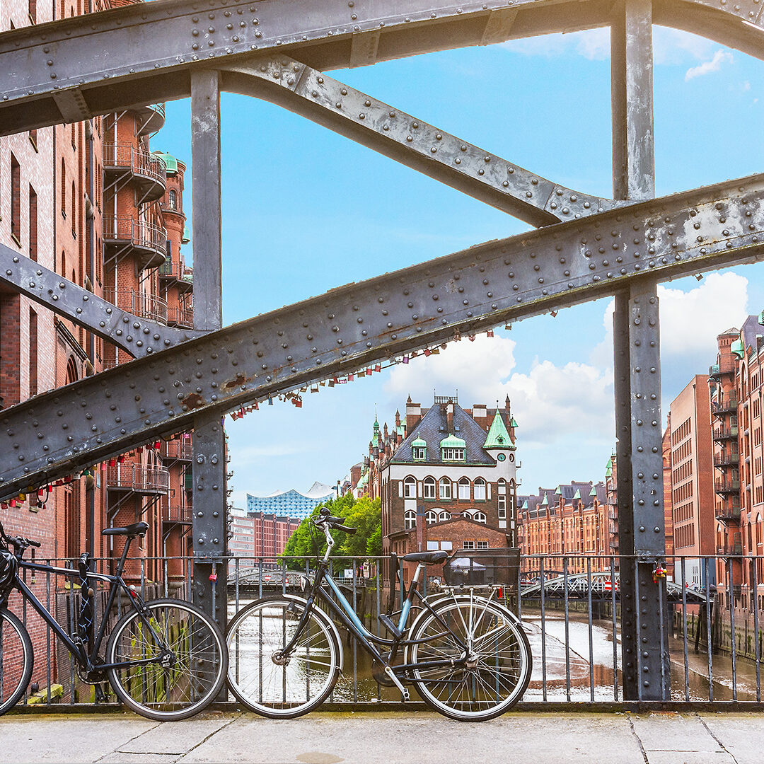 bicycles parked against iron handrail on a bridge in the old warehouse district Speicherstadt in Hamburg, Germany