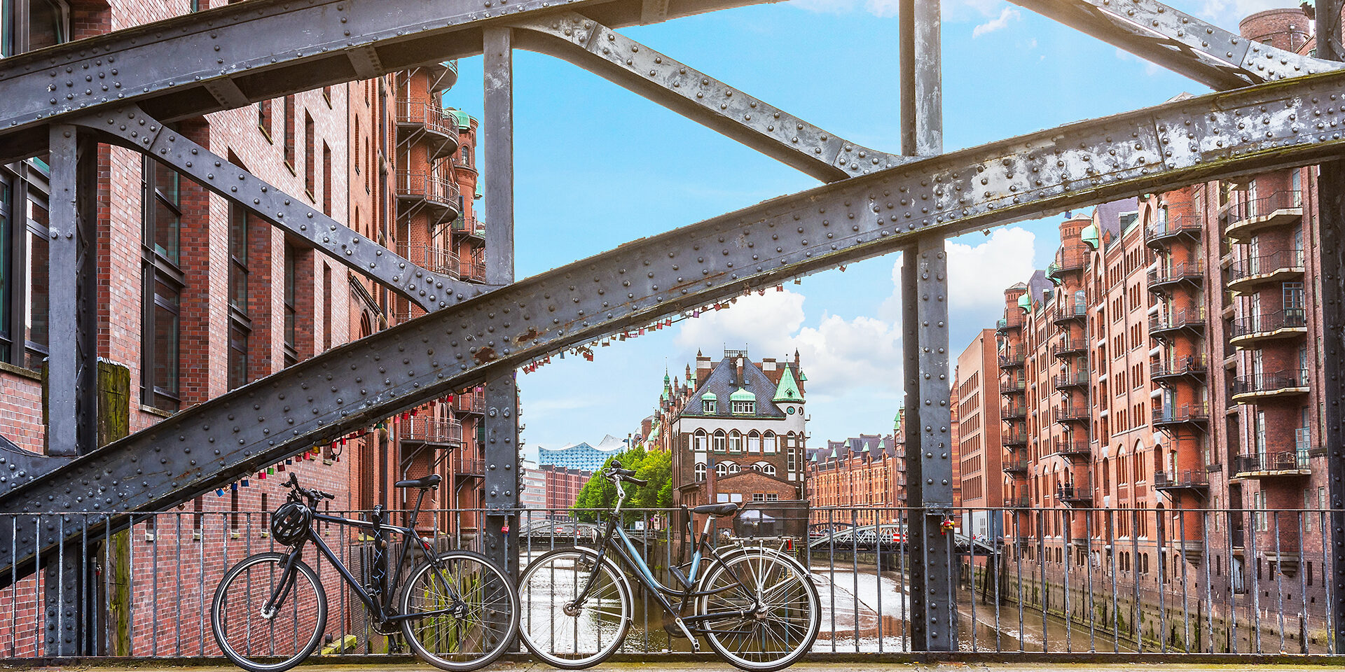 bicycles parked against iron handrail on a bridge in the old warehouse district Speicherstadt in Hamburg, Germany bicycles parked against iron handrail on a bridge in the old warehouse district Speicherstadt in Hamburg, Germany