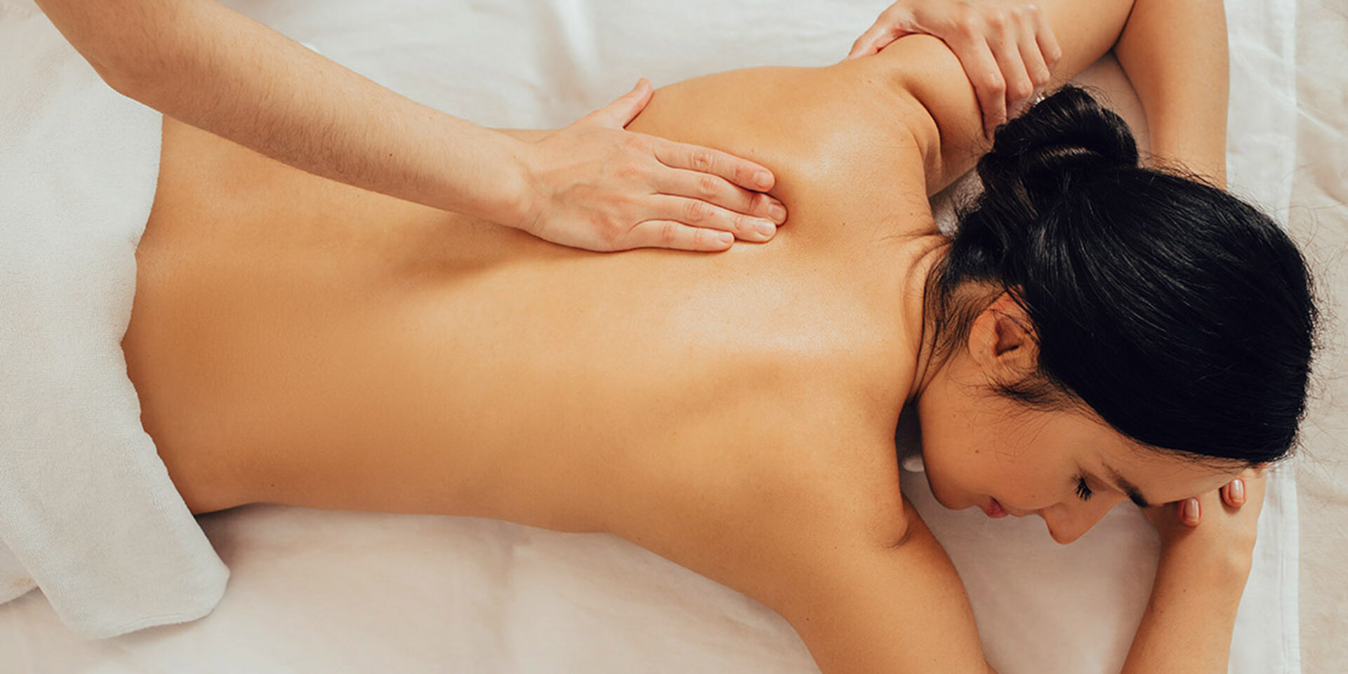 Beautiful mixed race woman enjoying a body massage, Ayurvedic massage using aroma oils. Thai body massage, aroma relaxation Beautiful mixed race woman enjoying a body massage, Ayurvedic massage using aroma oils. Thai body massage, aroma relaxation