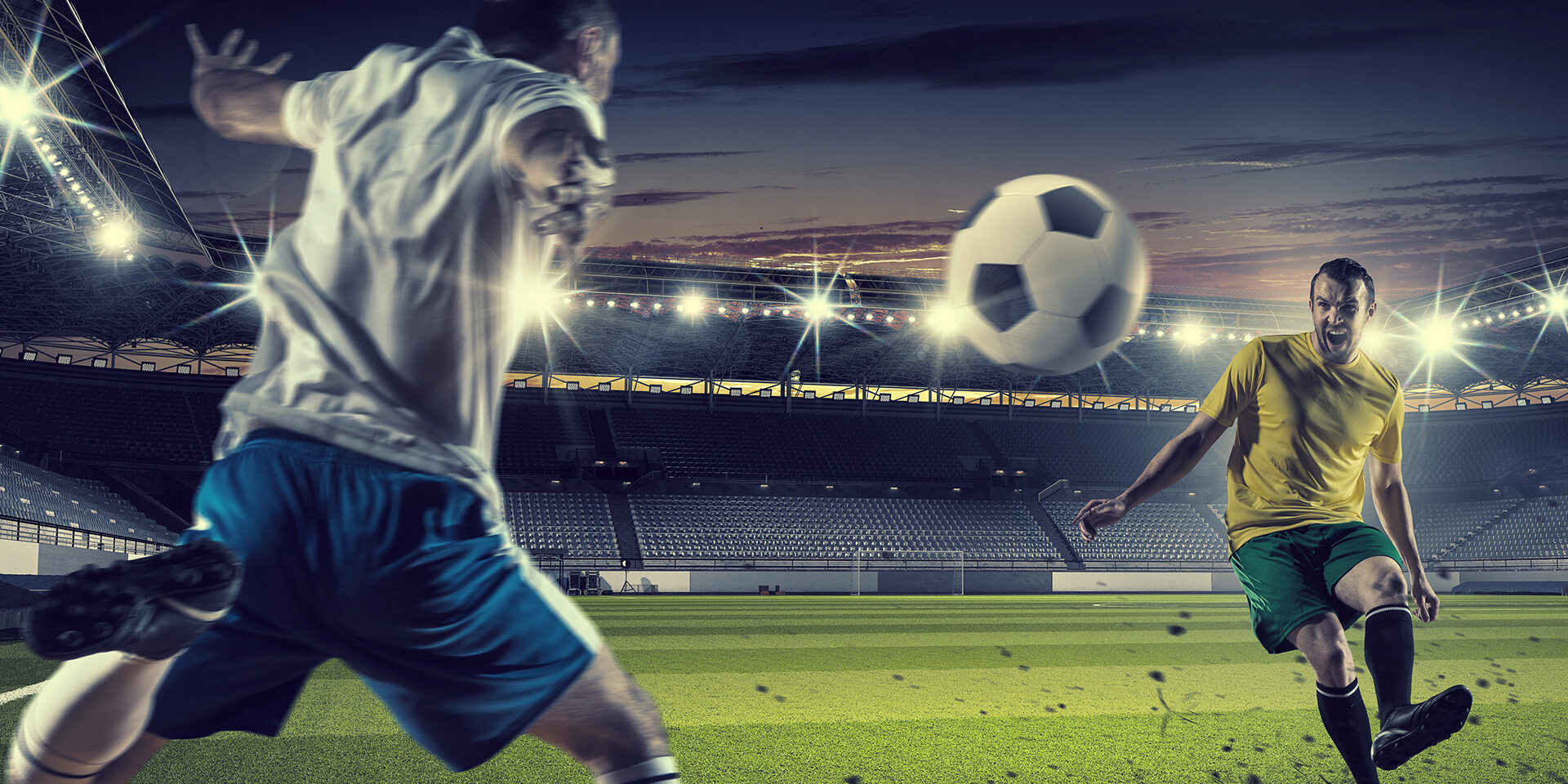 Football players at stadium field fighting for ball