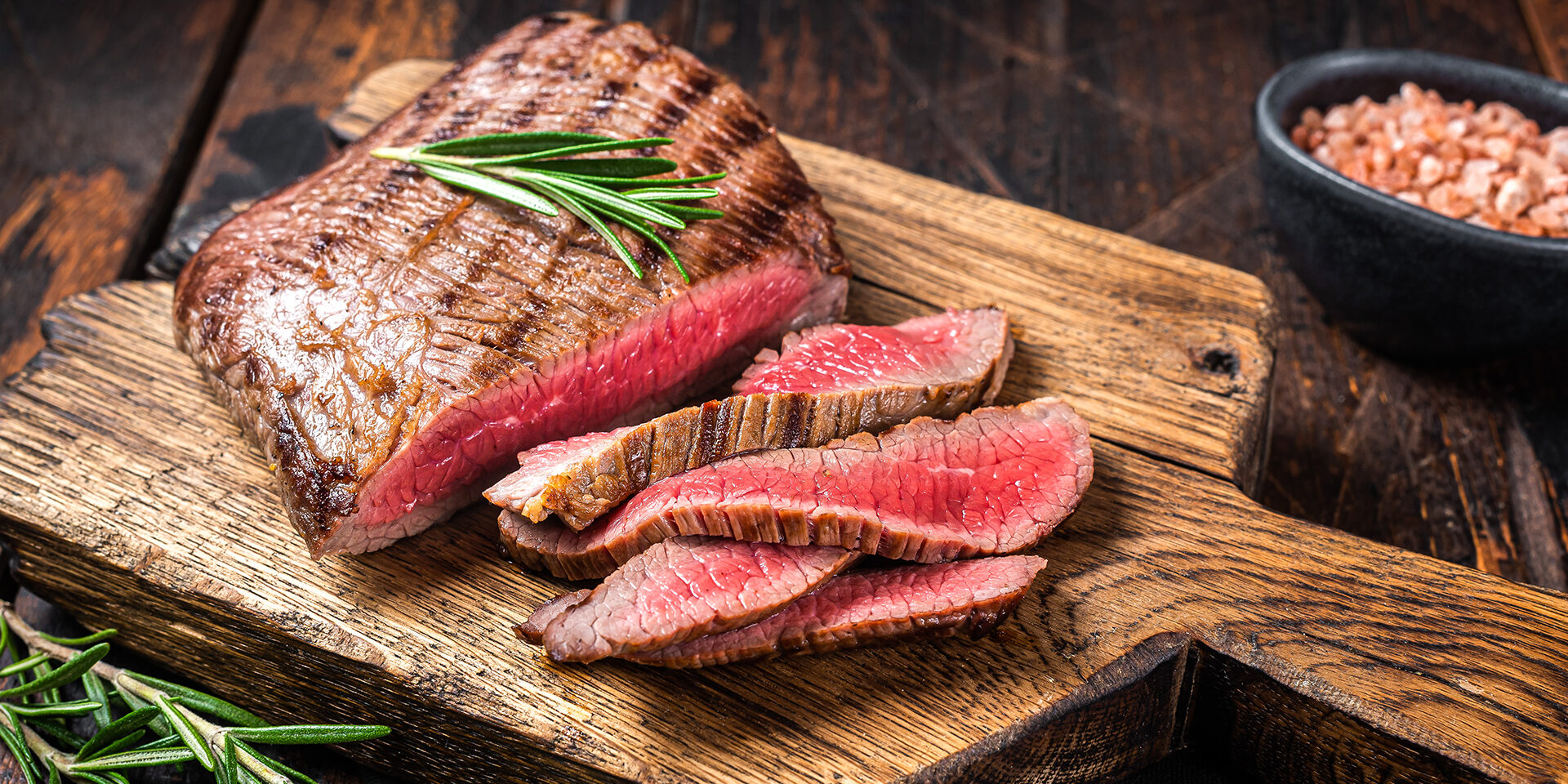 Barbecue dry aged wagyu Flank Steak on a cutting board. Wooden background. Top view Barbecue dry aged wagyu Flank Steak on a cutting board. Wooden background. Top view.