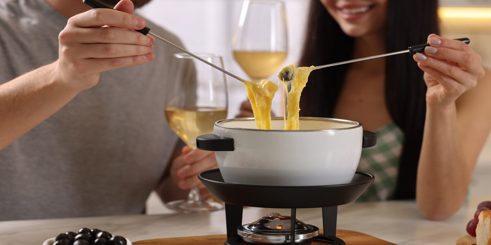 Couple,Enjoying,Cheese,Fondue,During,Romantic,Date,Indoors,,Closeup Couple enjoying cheese fondue during romantic date indoors, closeup