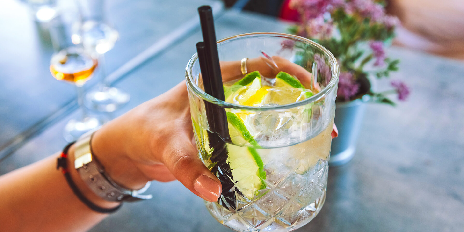 Close up of female hand holding Gin Tonic