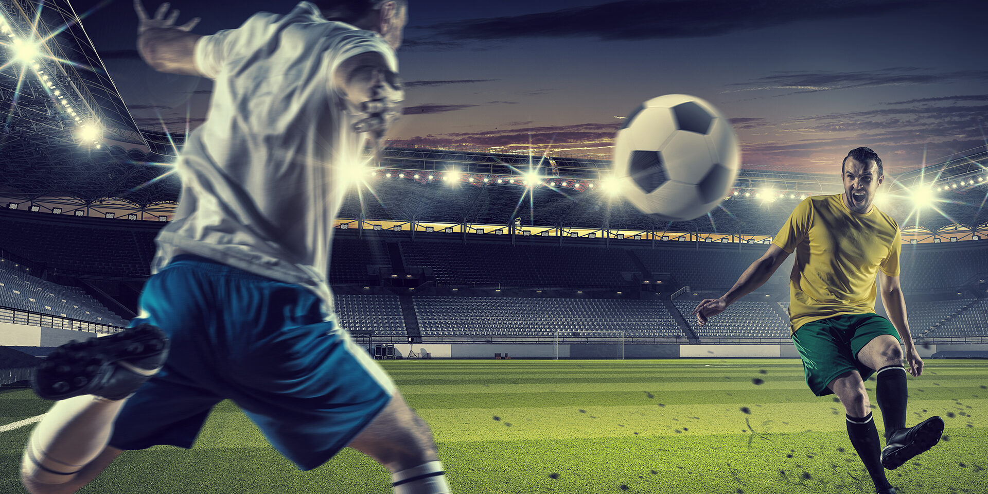 Football players at stadium field fighting for ball