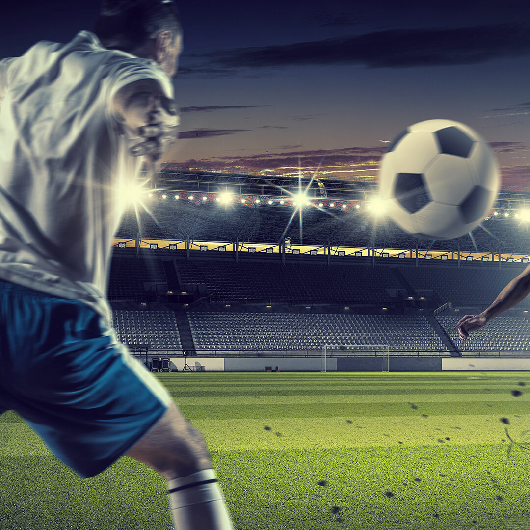 Football players at stadium field fighting for ball