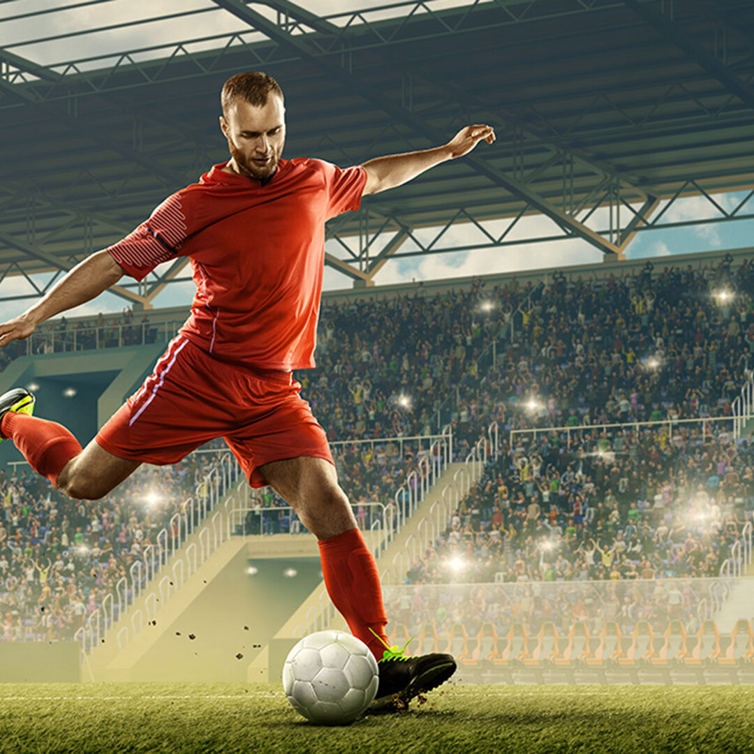 Professional soccer player with a ball in action. Night soccer stadium with fans cheering and dramatic sky. Sports event