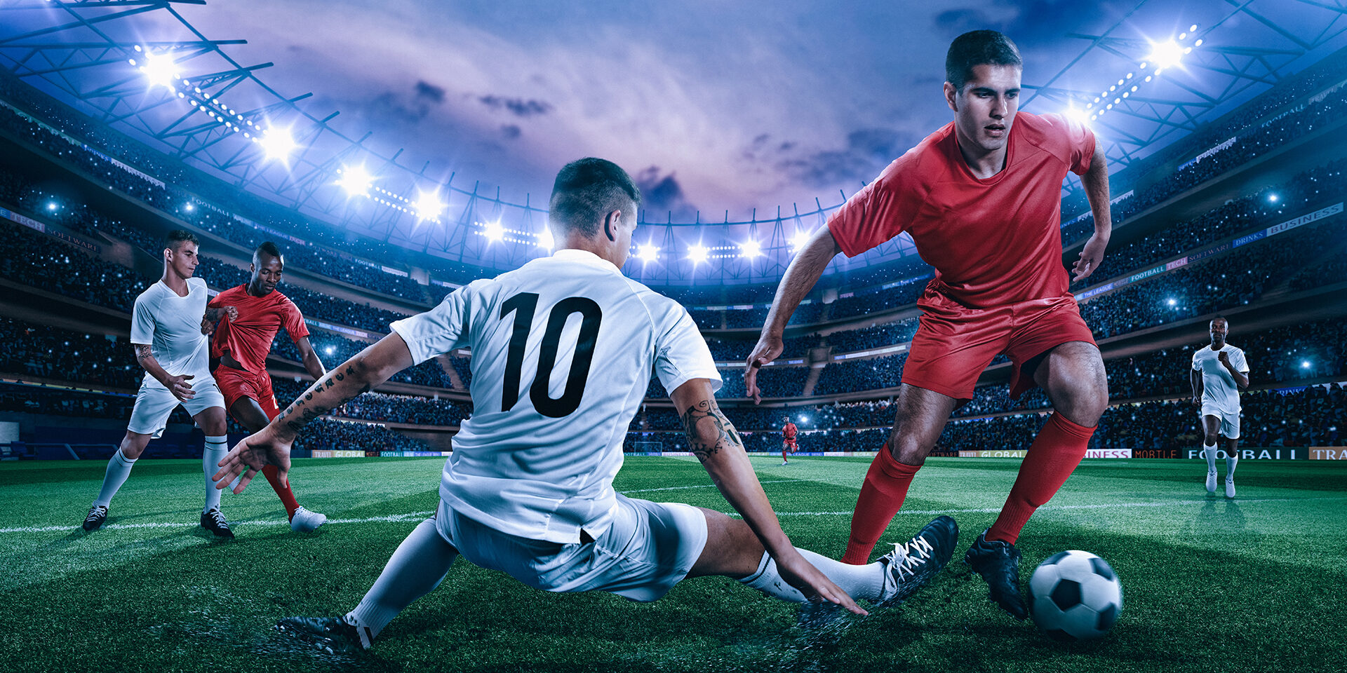 Soccer player in action on a professional arena full of spectators