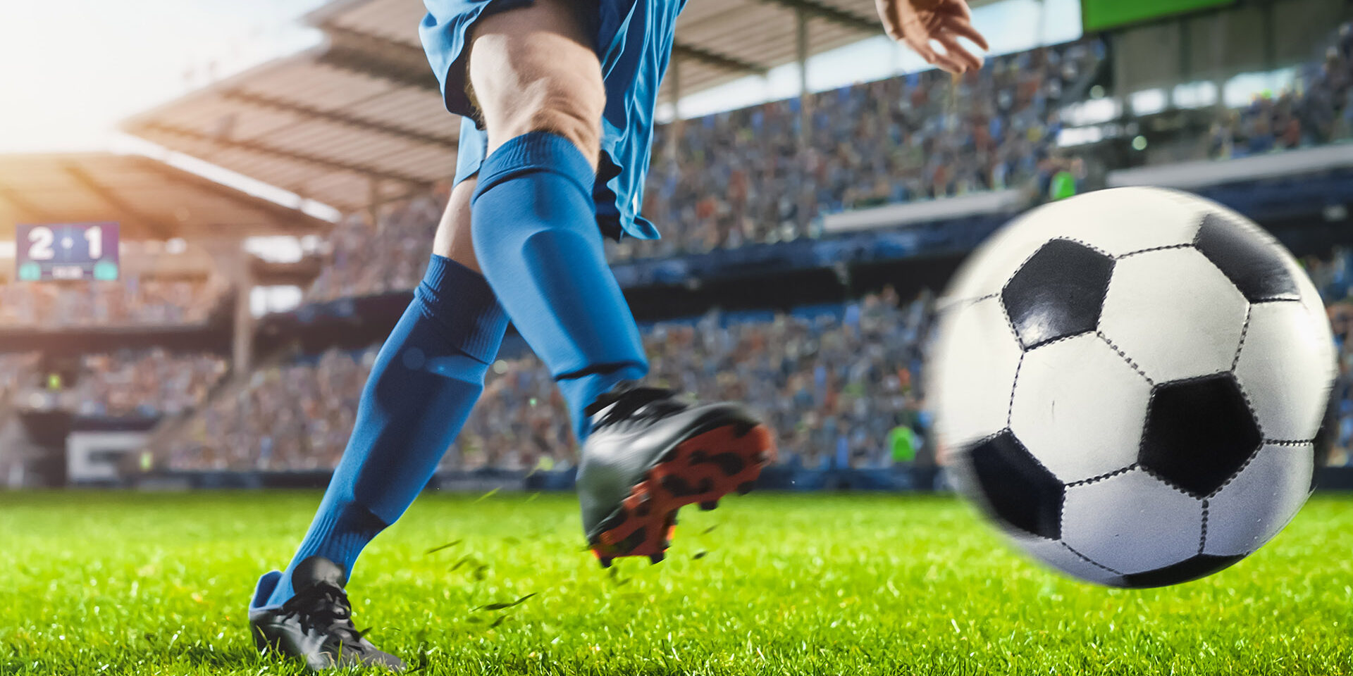 Football World Championship: Soccer Player Runs, Kicks the Ball. Ball Shoots, Grass Sprays Outwards, Full Stadium Crowd Cheers. Cinematic Shot Captures Glorious Victory. International Tournament.