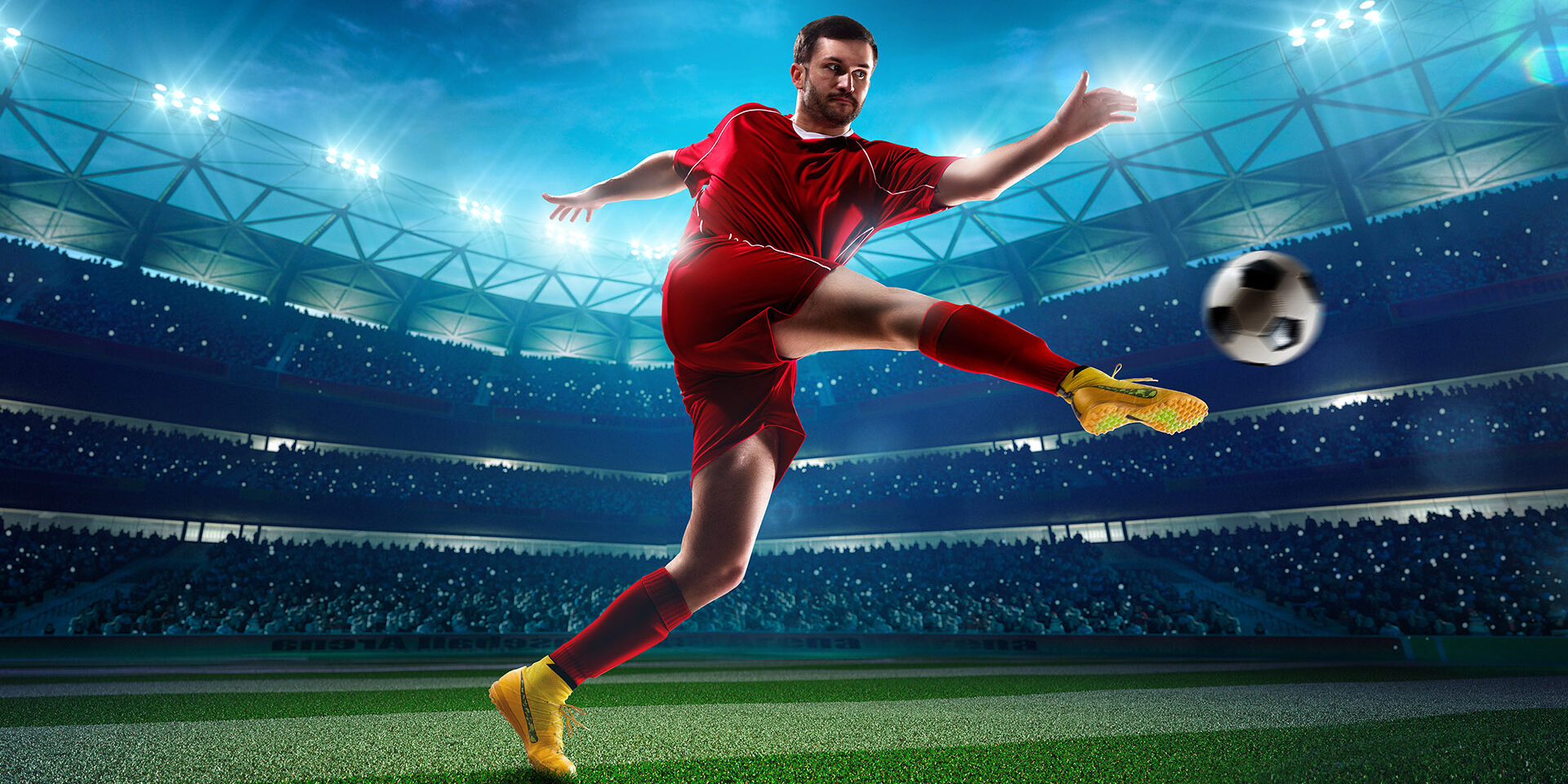 Soccer player in action on night stadium background