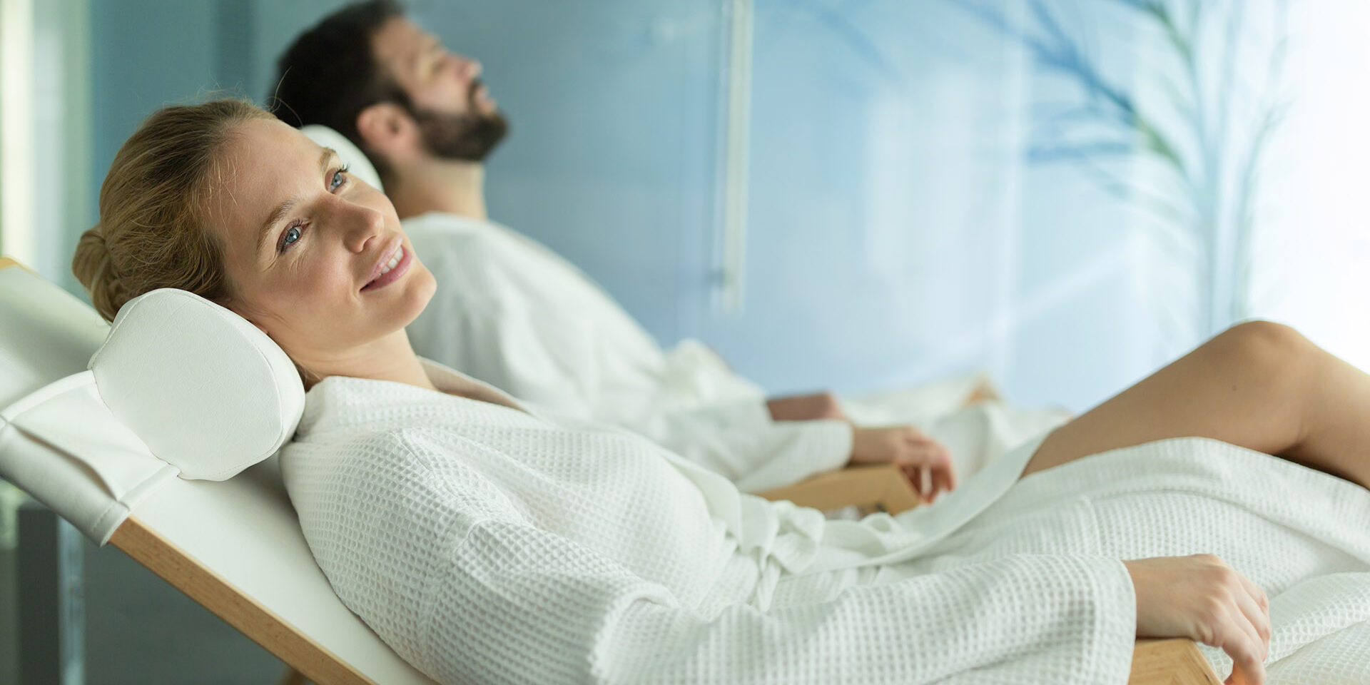 Happy married couple relaxing at wellness spa resort