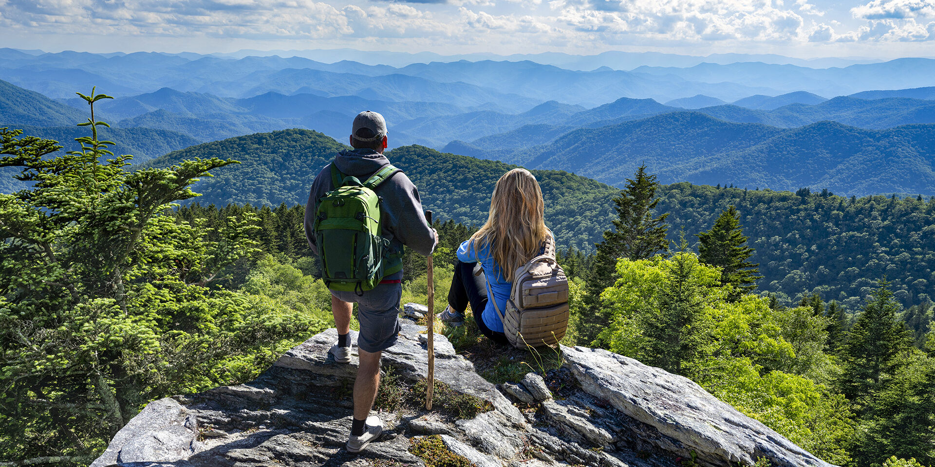 Couple on top of the mountain enjoying beautiful view. Blue Ridge Mountains, near Asheville, North Carolina.USA.