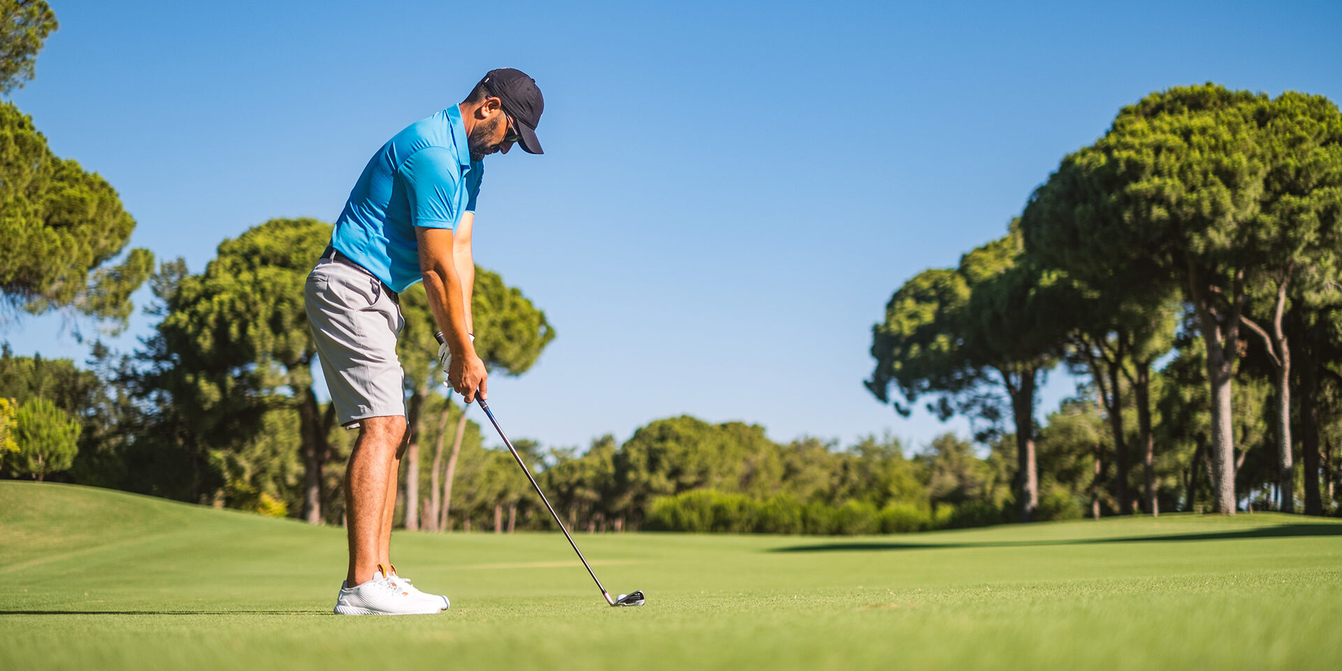 Man playing golf on field.