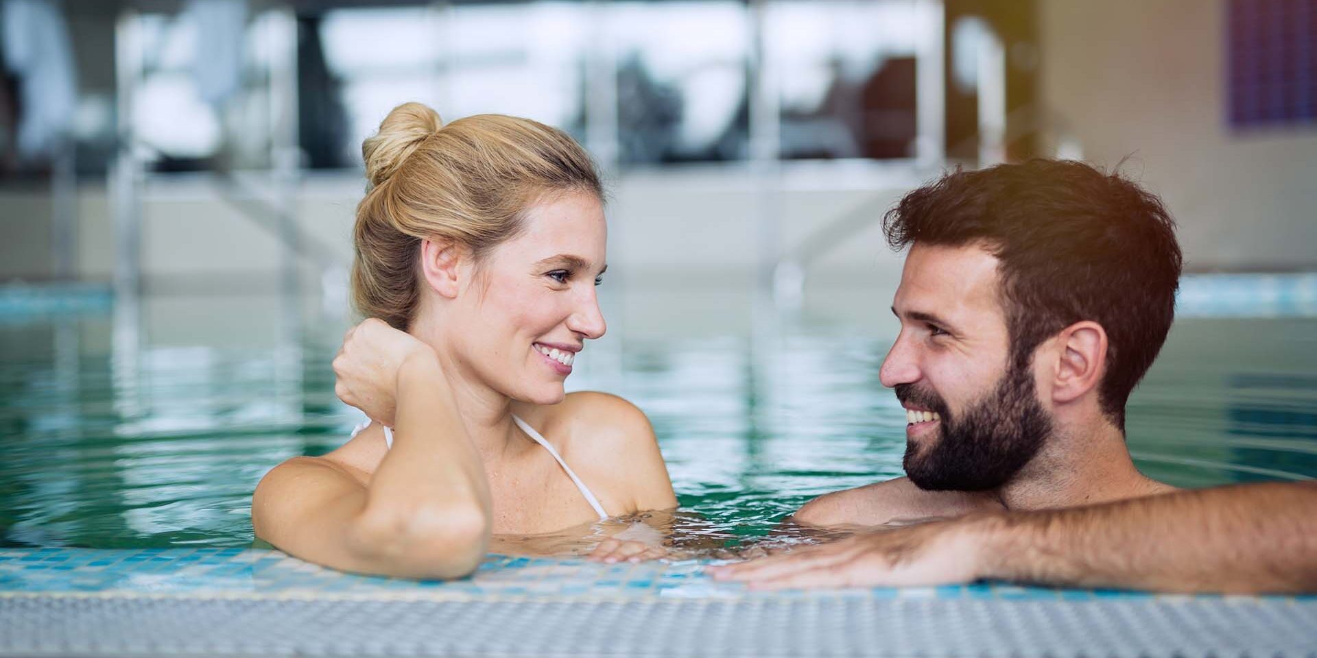 Romantic couple enjoying thermal bath spa and wellness center Romantic couple enjoying thermal bath spa and wellness center