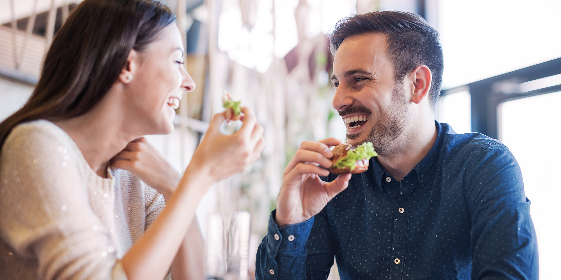 Happy loving couple enjoying breakfast in a cafe. Love, dating, food, lifestyle