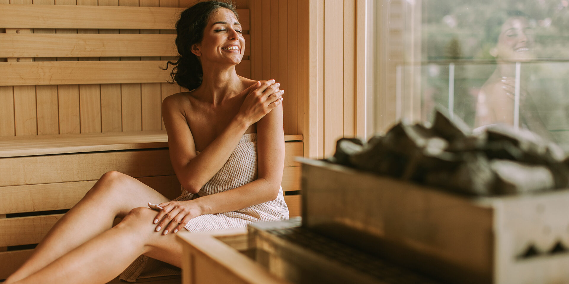 Attractive young woman relaxing in the sauna