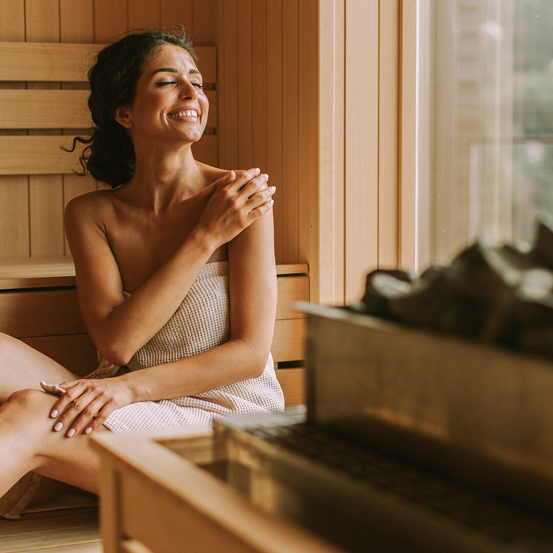 Attractive young woman relaxing in the sauna