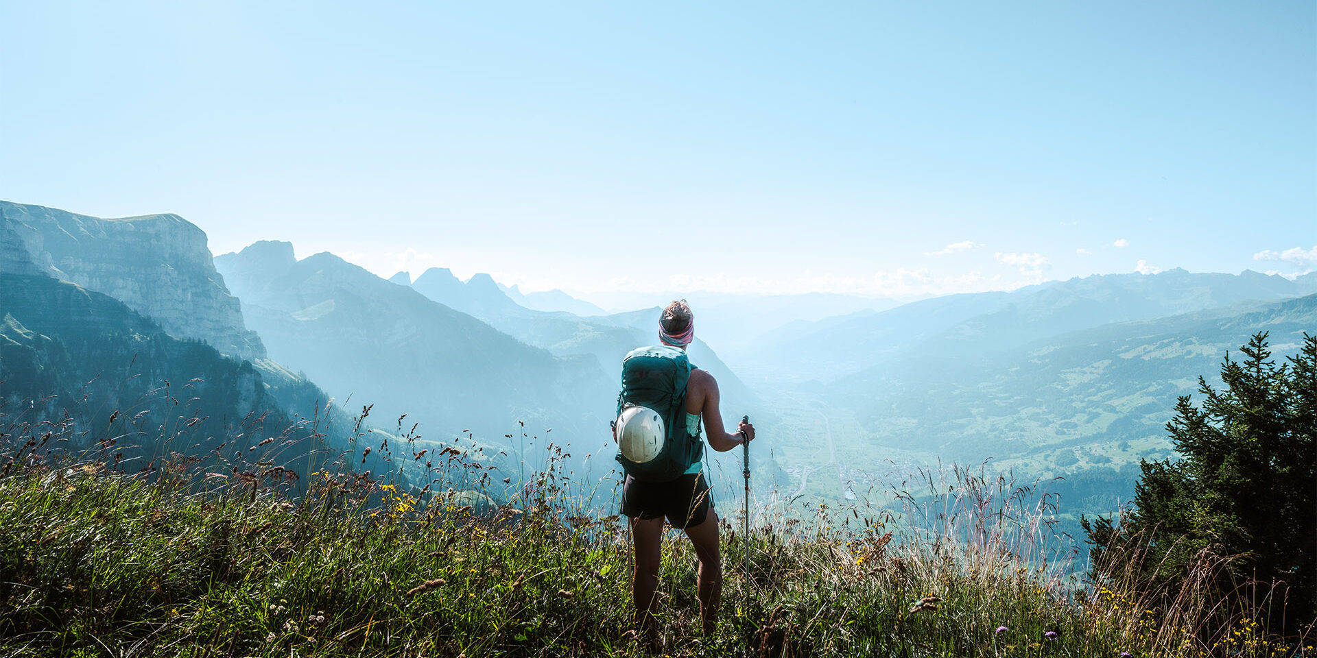 Athletic woman enjoys the view from a vantage point on the Walensee in the morning. Description: Athletic woman enjoys the view from a vantage point on the Walensee in the morning. Schnürliweg, Walensee, St. Gallen, Switzerland, Europe.