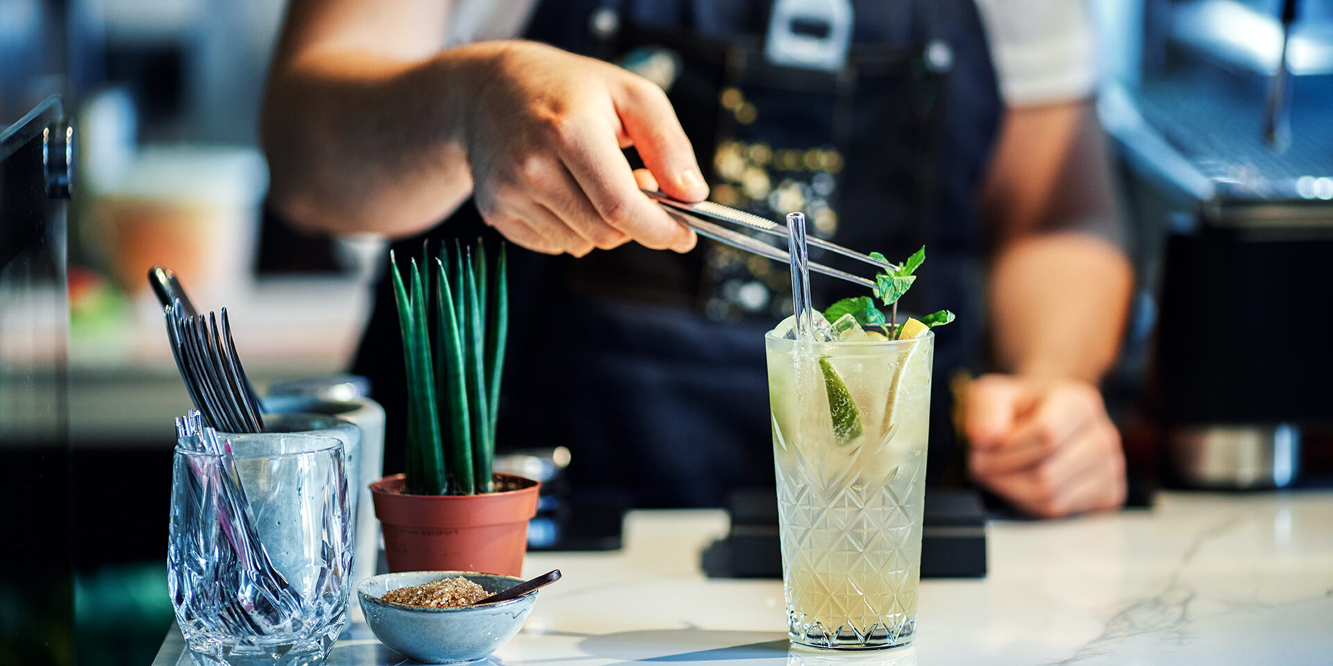 Bartender Mixing Cocktail with Mint Close up of bartender mixing cocktail garnished with fresh mint leaves
