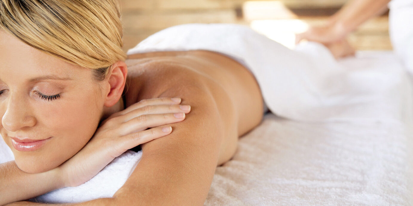 Woman Getting Therapeutic Massage --- Image by © Mina Chapman/Corbis