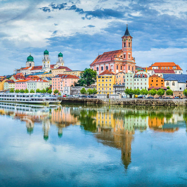 Panoramic view of the historic city of Passau reflecting in famous Danube river in beautiful evening light at sunset, Bavaria, Germany